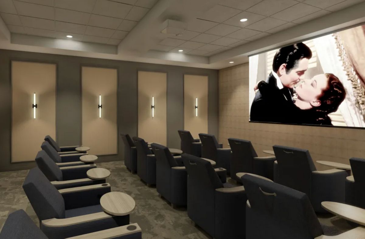 A cozy home theater with comfortable seating and a large screen.