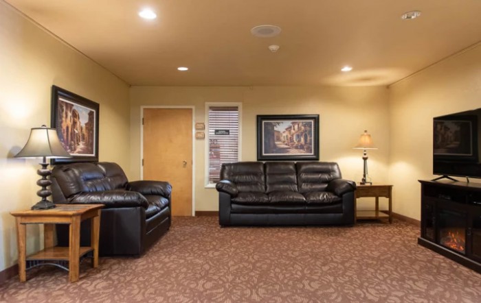 A cozy living room with comfortable sofas and warm lighting.