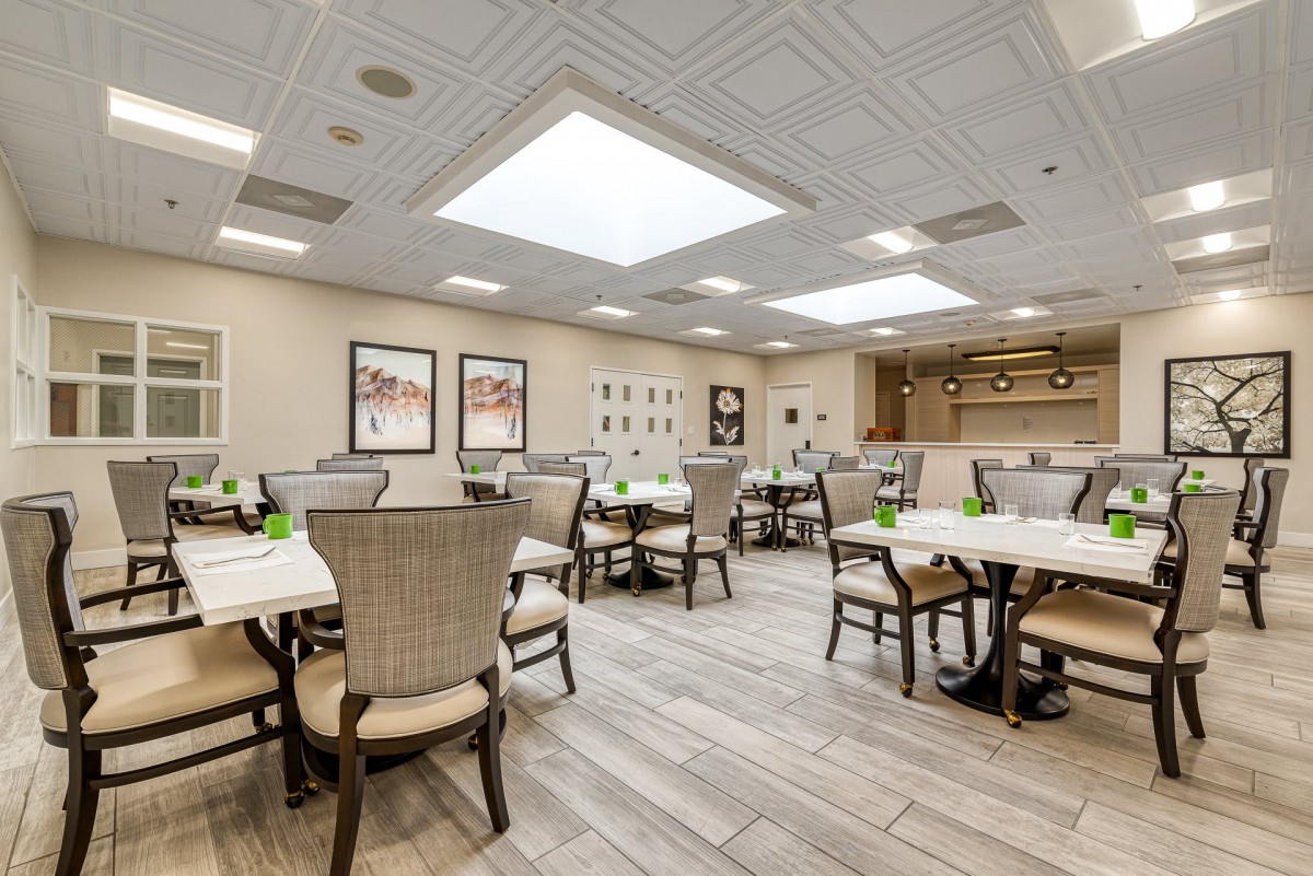 A spacious and modern dining area with elegant furniture and contemporary decor.