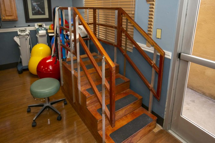 A set of stairs with handrails used in a rehabilitation or physical therapy setting.