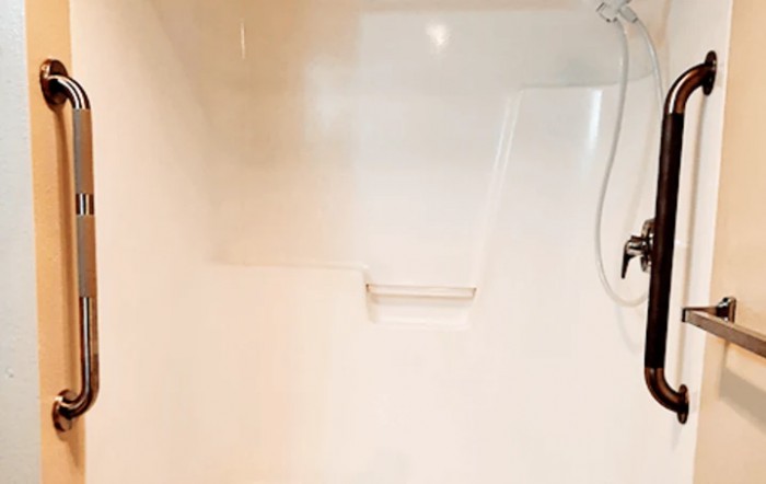 A clean and minimalist shower area in a bathroom.