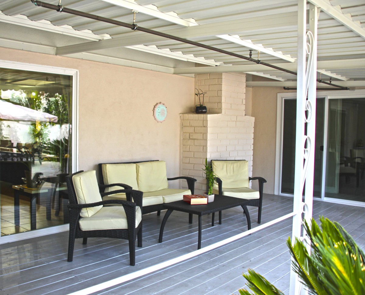 A cozy patio with outdoor seating under a covered porch.