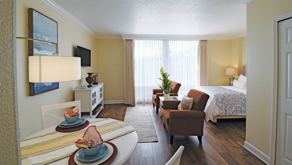 A cozy living room and dining area in a modern apartment with stylish decor.