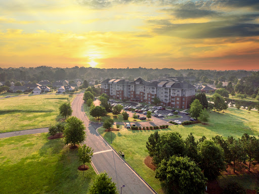 A serene sunset over a peaceful residential neighborhood, showcasing a beautiful blend of nature and urban living.