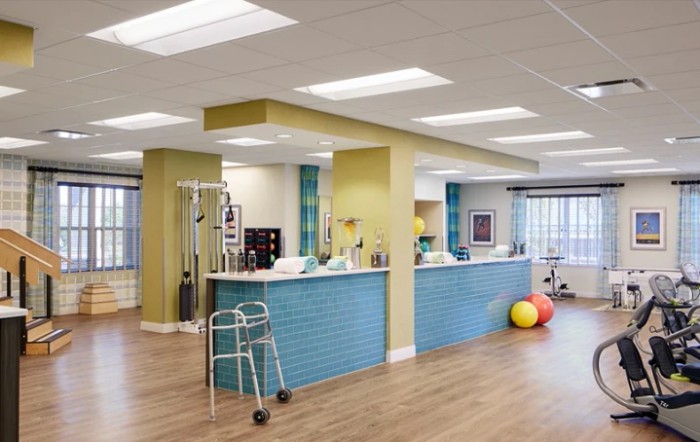 A modern rehabilitation center with therapy equipment and exercise tools.