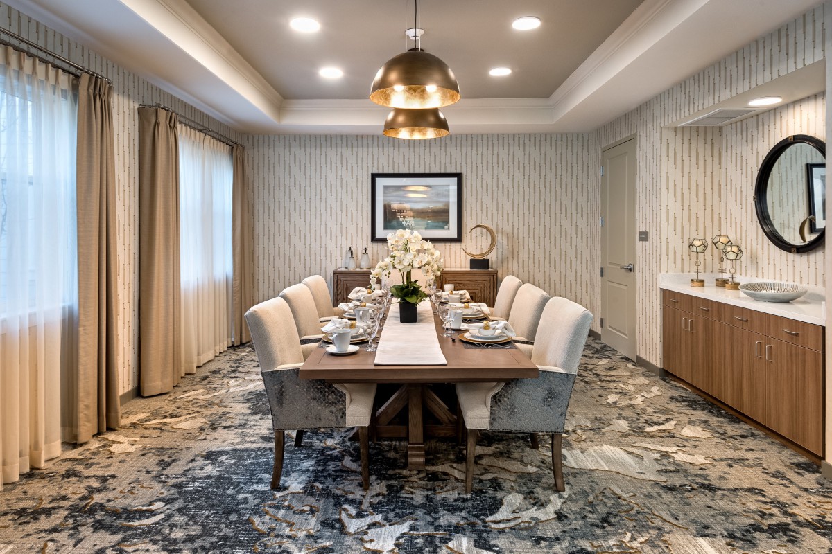 Elegant dining room with a modern chandelier and sophisticated table setting.