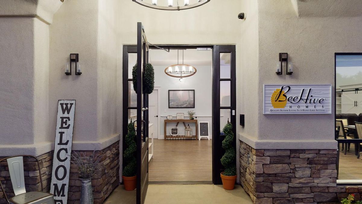 A welcoming entrance to a stylish lobby with elegant lighting and potted plants.