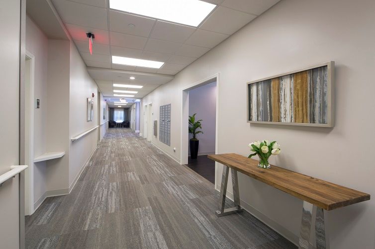 A modern office hallway with stylish decor and lighting.