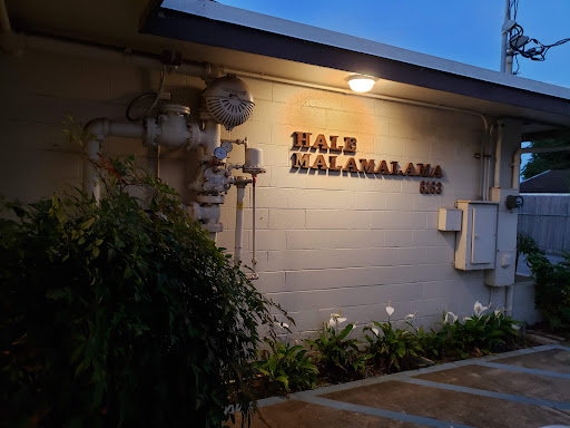 Night view of the Hale Kahalana building, showcasing its illuminated sign.