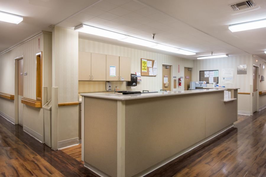 A hospital reception area with a front desk and medical equipment.