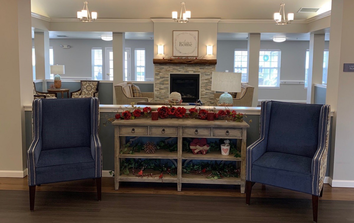 A cozy living room with elegant decor, featuring a fireplace and comfortable seating.
