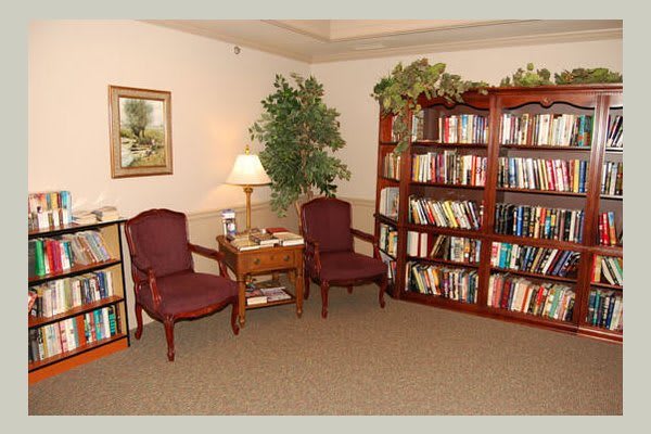 A cozy reading corner with bookshelves and comfortable seating.