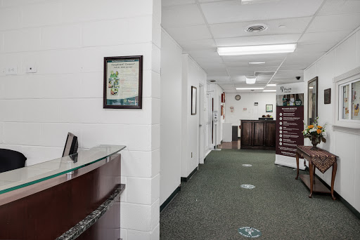 A view of a modern office lobby with a reception desk and hallway.