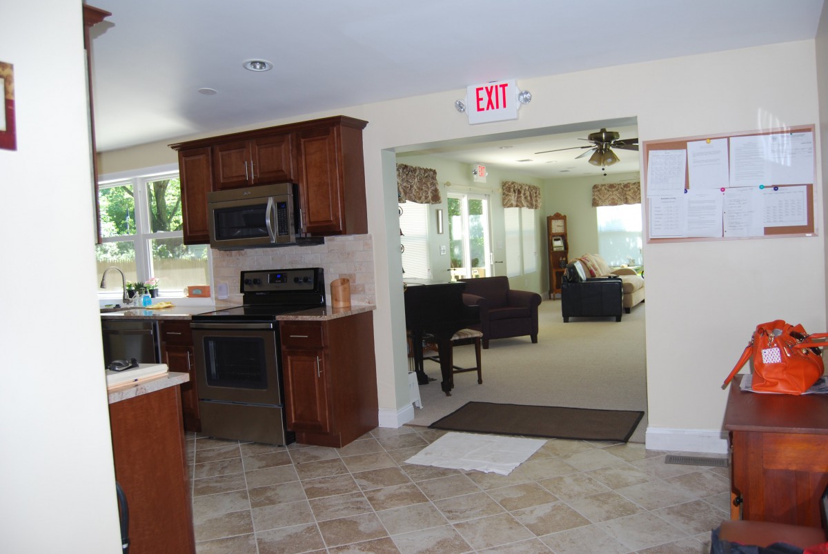 A modern open floor plan featuring a kitchen and adjoining living area.