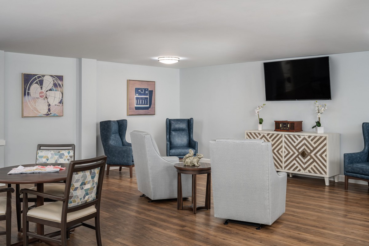 A modern living room with comfortable seating and a mounted television.