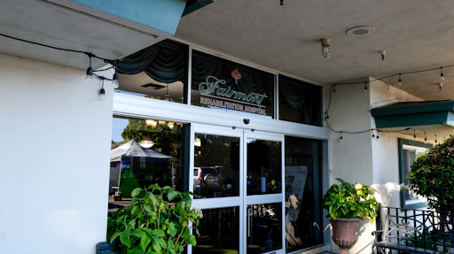 The entrance of a cozy restaurant showcasing its name through an elegant sign.