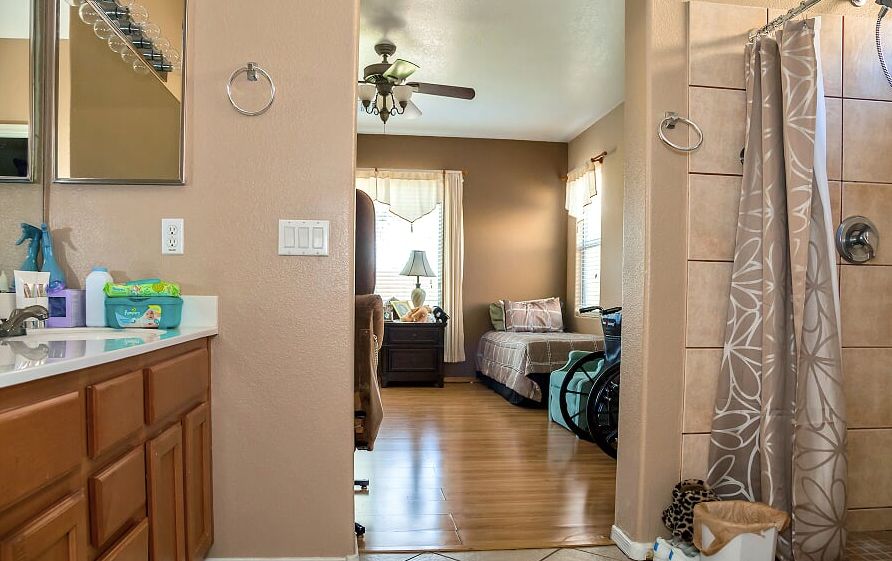 A cozy indoor space featuring a living room with hardwood floors and daylight streaming in through the windows.