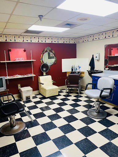 A cozy barbershop interior featuring a checkerboard floor and stylish seating.