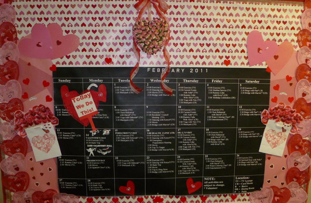 A February calendar adorned with Valentine's Day decorations, featuring a heart-themed background and detailed daily schedule.