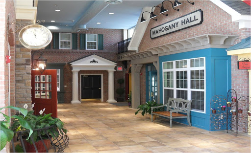 A beautifully designed indoor hallway featuring various architectural elements and decorative plants.