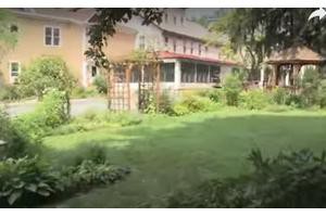 A lush garden in front of a large building.