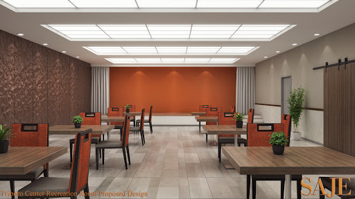A spacious and modern dining area featuring wooden tables and chairs, complemented by an orange accent wall.