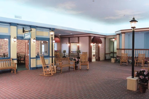 A cozy interior lobby featuring rocking chairs and a welcoming atmosphere.