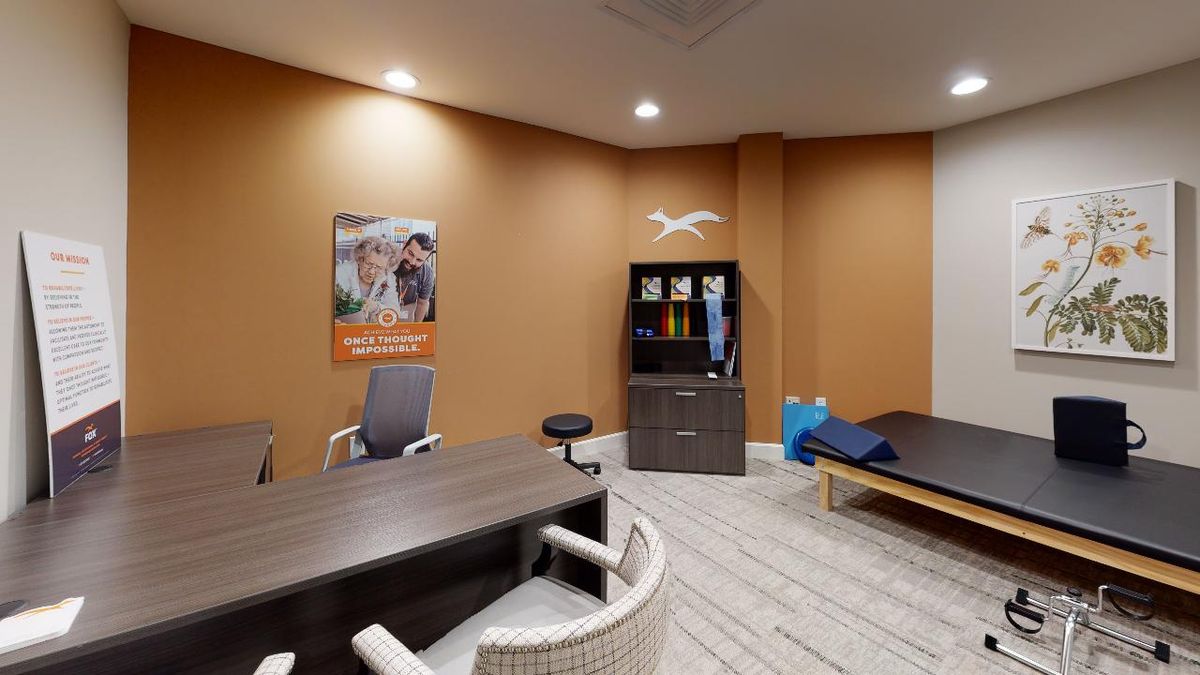 A well-organized office space featuring a desk, chairs, and a cabinet.