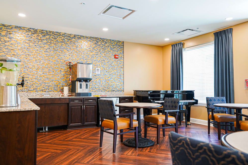 A cozy hotel lobby with a coffee machine and seating area.