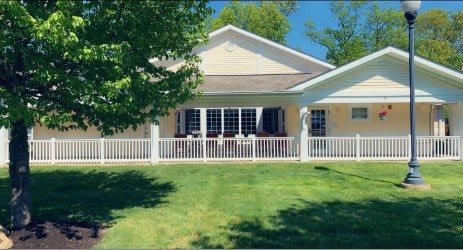A single-story house with a porch and a well-maintained front yard.