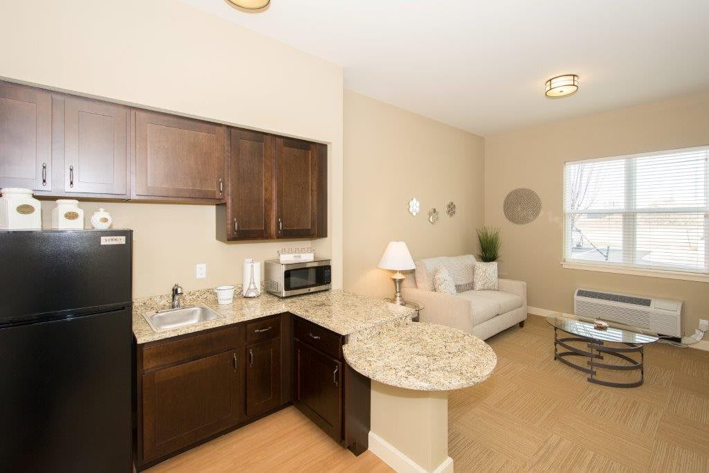 A modern apartment interior with a compact kitchen and cozy living area.