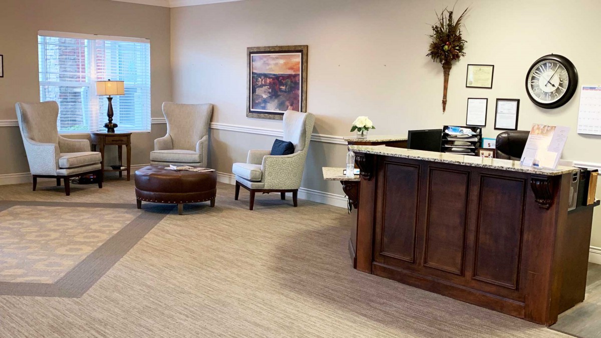 A cozy waiting room with chairs, a table, and decorative elements.