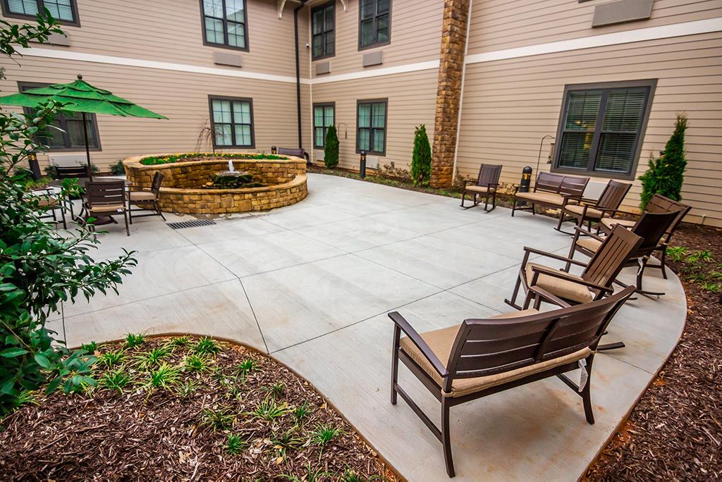 A serene courtyard with comfortable seating and a fountain centerpiece, perfect for relaxation.