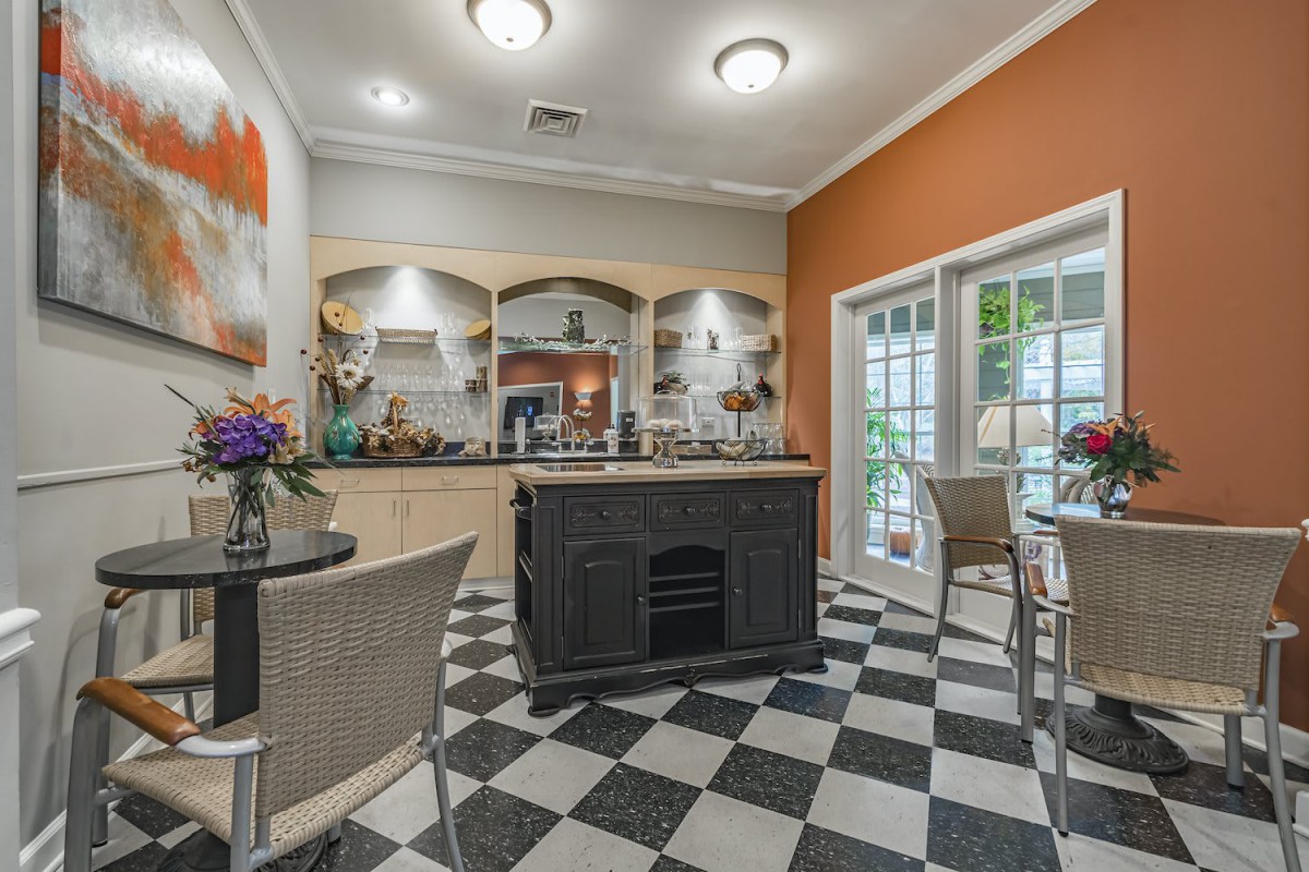 A modern kitchen with a checkered floor and an island seating area.