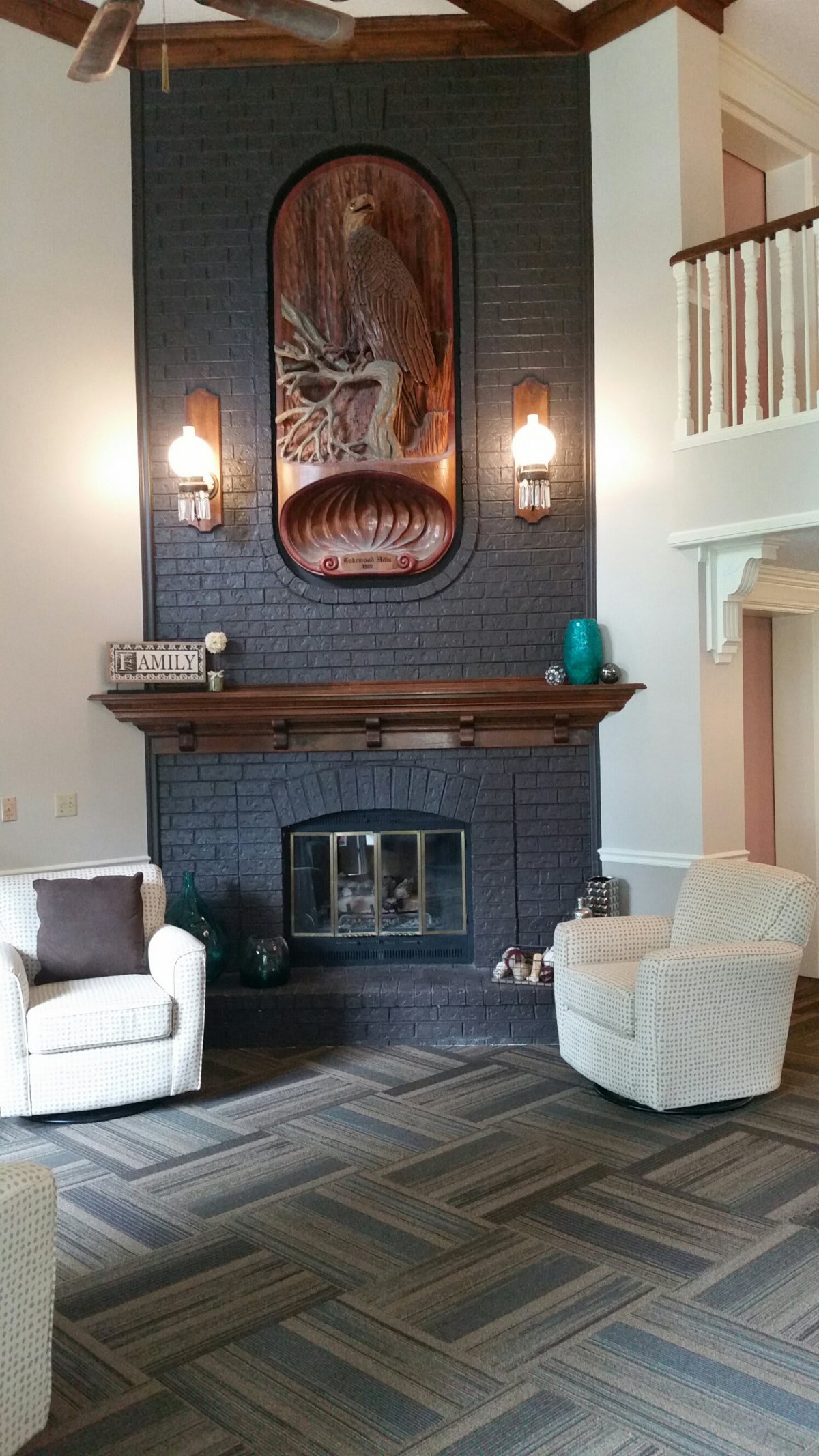 A modern living room with a brick fireplace and cozy seating.