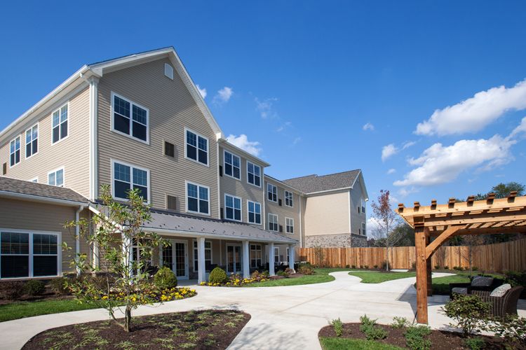 A modern residential apartment building under a clear blue sky.