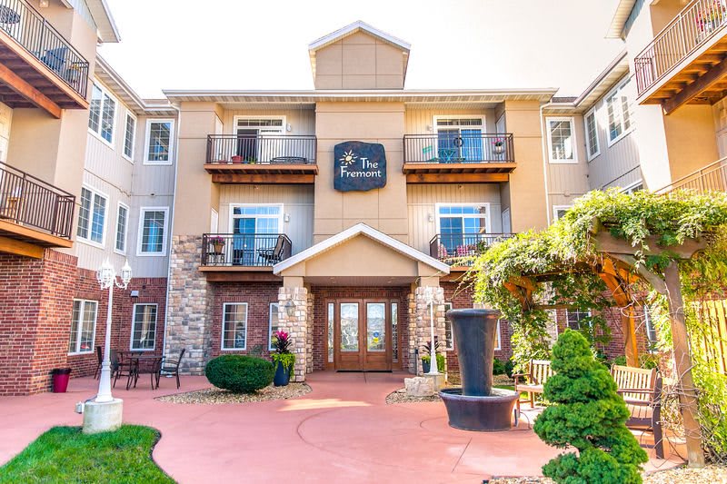 A welcoming hotel entrance featuring landscaped surroundings and a modern architectural design.