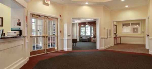 A spacious interior lobby featuring a welcoming atmosphere with natural light, plush furniture, and well-defined spaces.