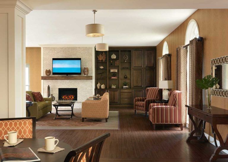 A modern and cozy living room with a fireplace and comfortable seating.