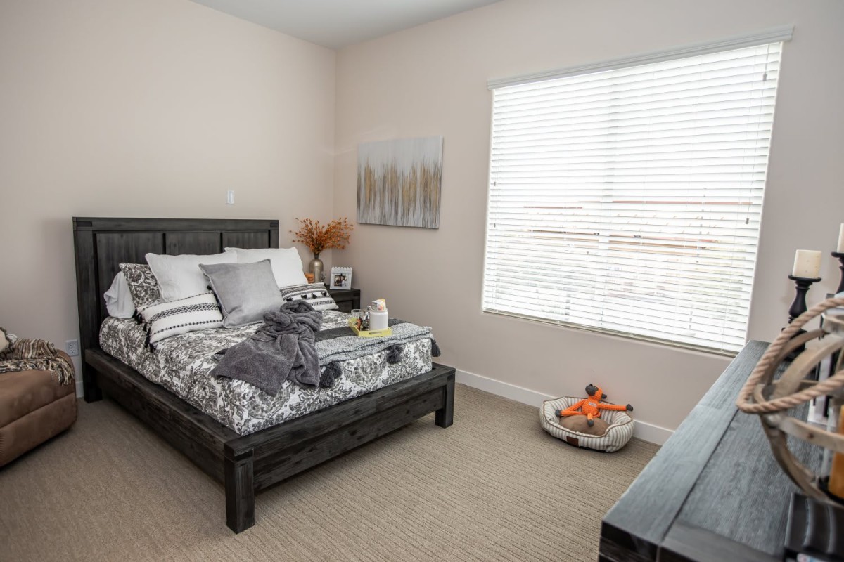 A cozy bedroom with neutral colors and modern decor.