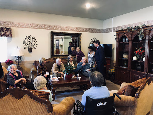 A cozy indoor gathering with a group of people engaged in conversation.