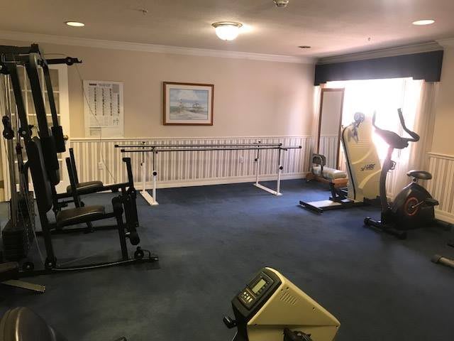A small gym room with exercise equipment including a treadmill.