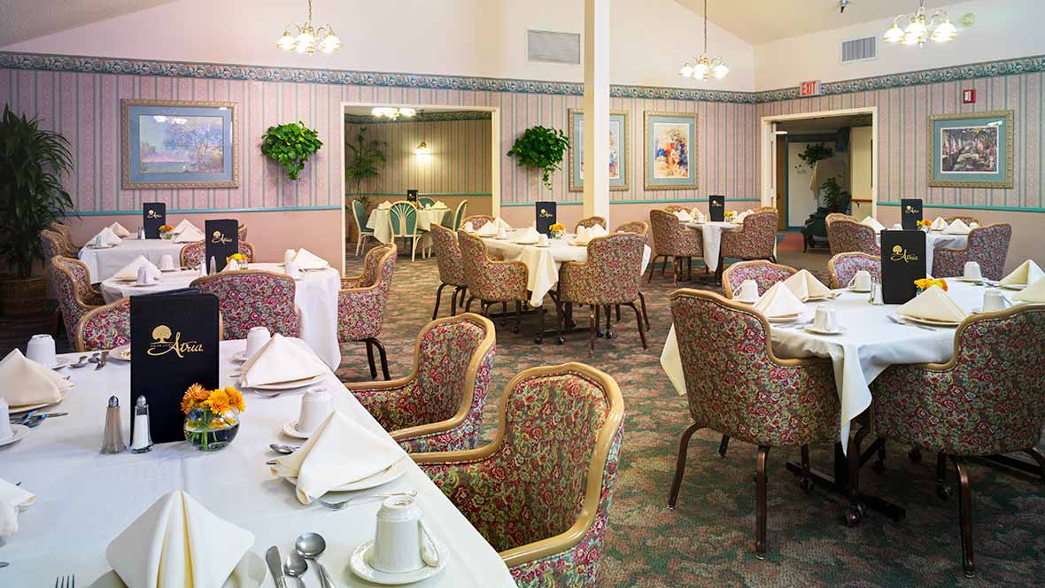 An elegant dining area set with tables and chairs, featuring thoughtful interior design.