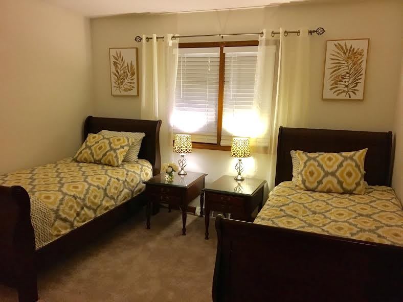 A cozy bedroom with twin beds and matching decor.