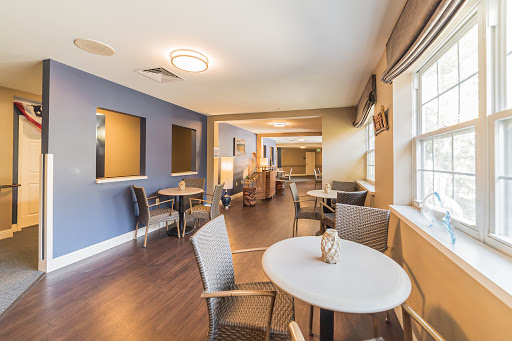 A cozy lounge area featuring modern furniture and a calming blue color scheme.