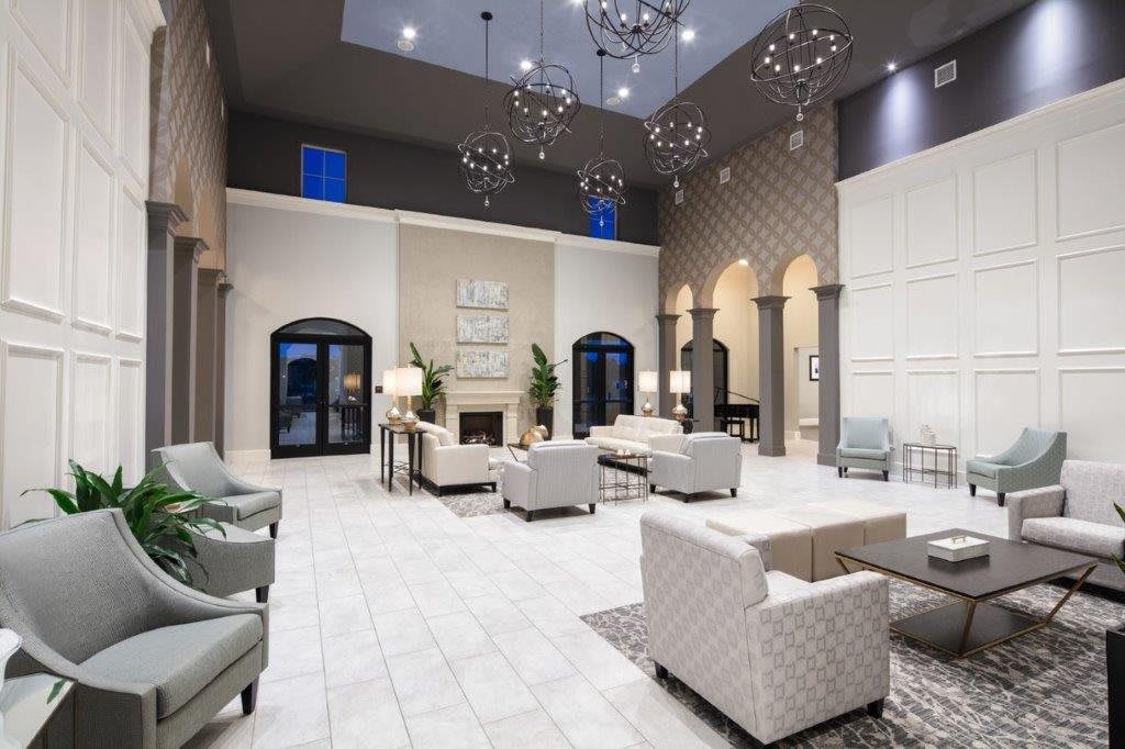 A luxurious, modern lobby with elegant chandeliers and stylish seating.