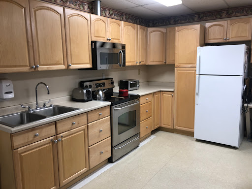 A well-organized kitchen featuring wooden cabinets and essential appliances.
