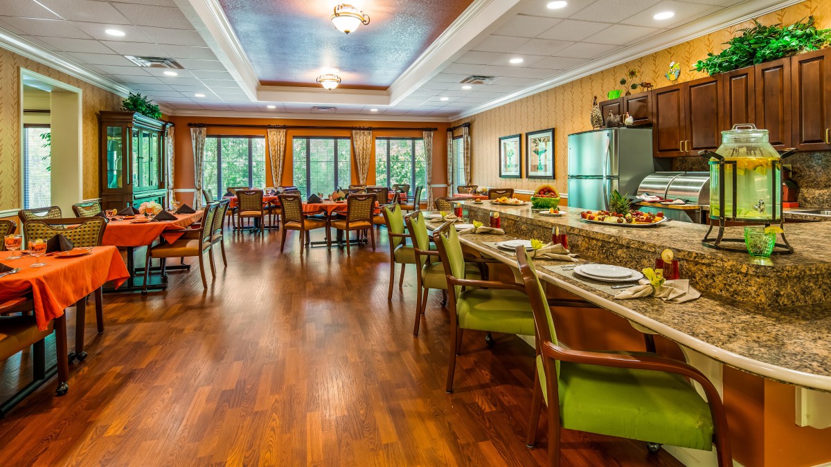 A spacious dining area with elegant decor and wooden flooring.
