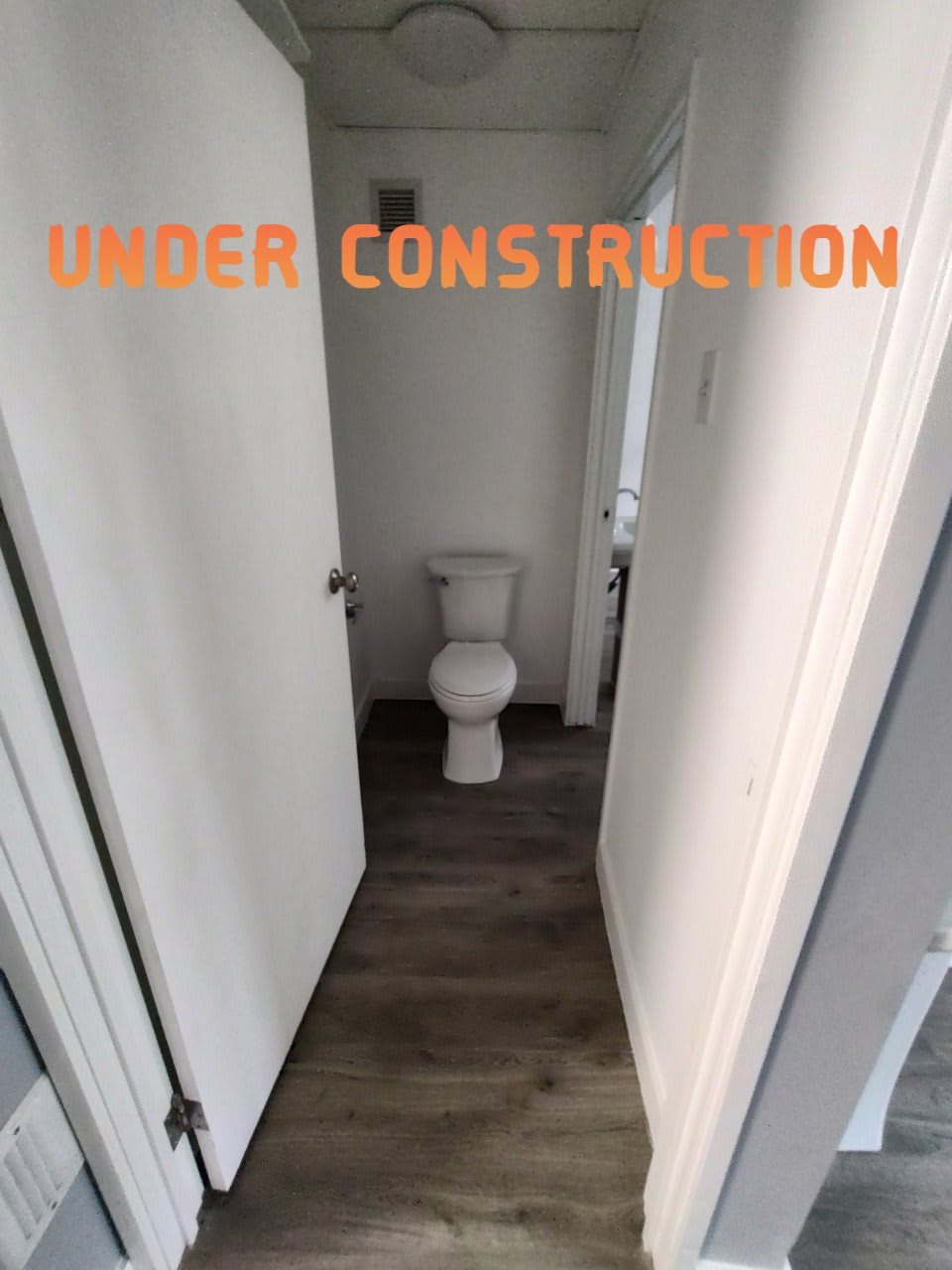 A bathroom under construction featuring a visible toilet.