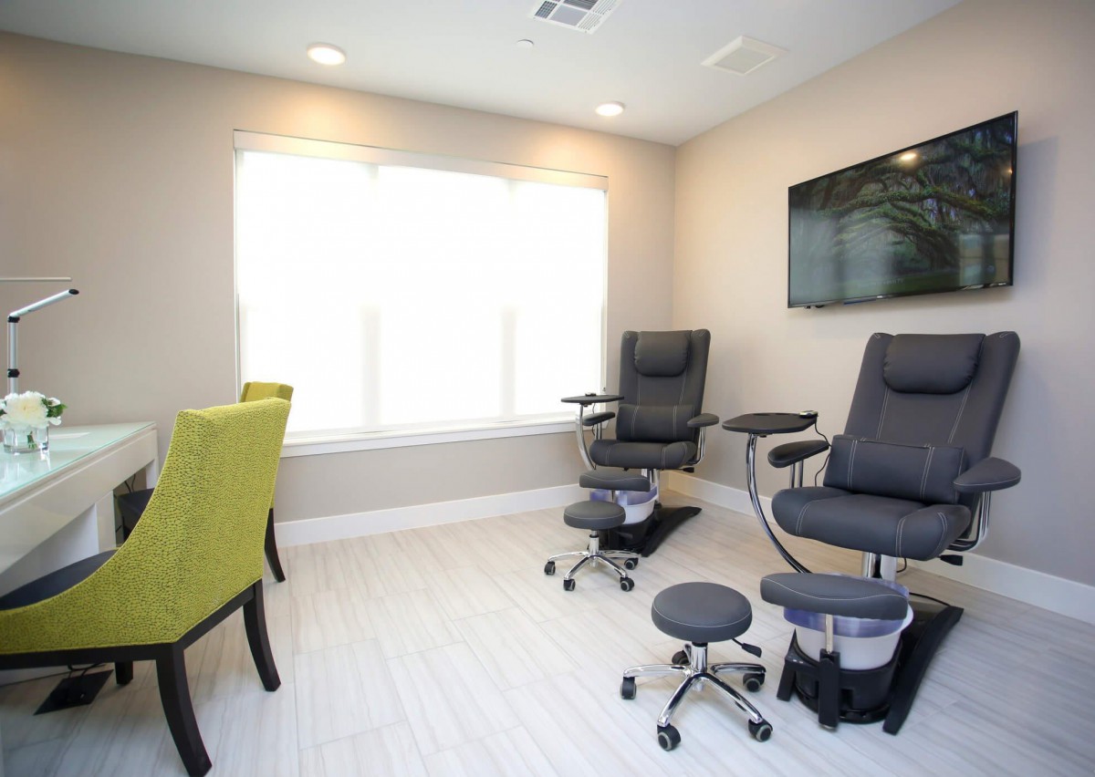 A modern pedicure station with massage chairs in a relaxing spa setting.